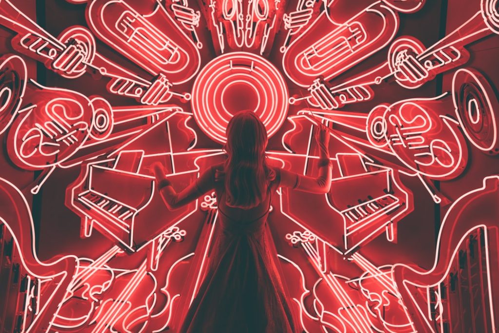 woman standing in front of jazz instrument art