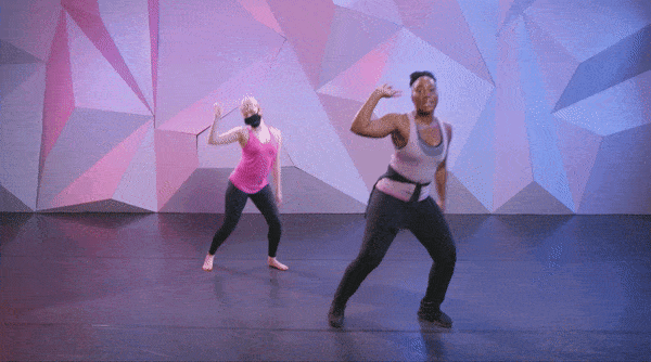 dancer saleemah knight and her assistant hopping from one foot to another while shaking their finger