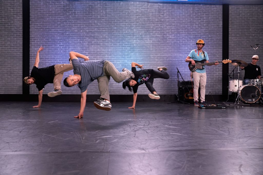 dancer Vince Horiuchi balancing on one arm in a break dancing class