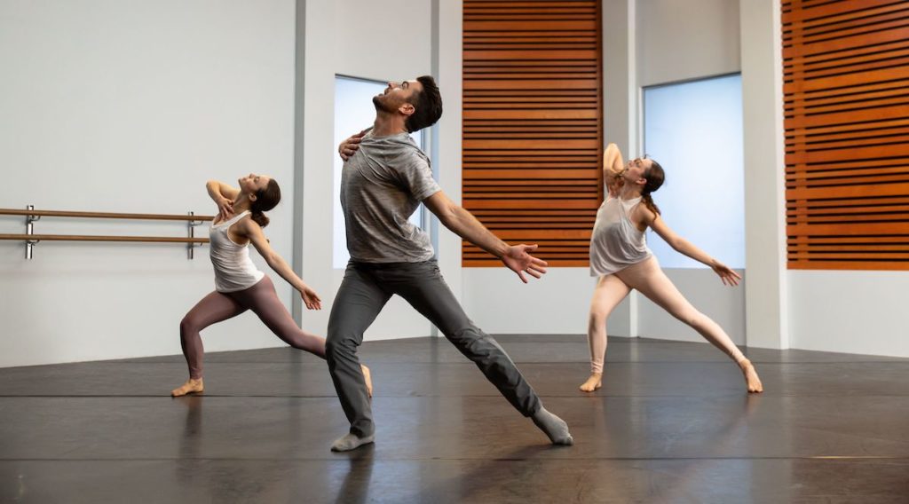 teddy forance and 2 other dancers posing with one hand on chest and one leg extended at cli studios. 