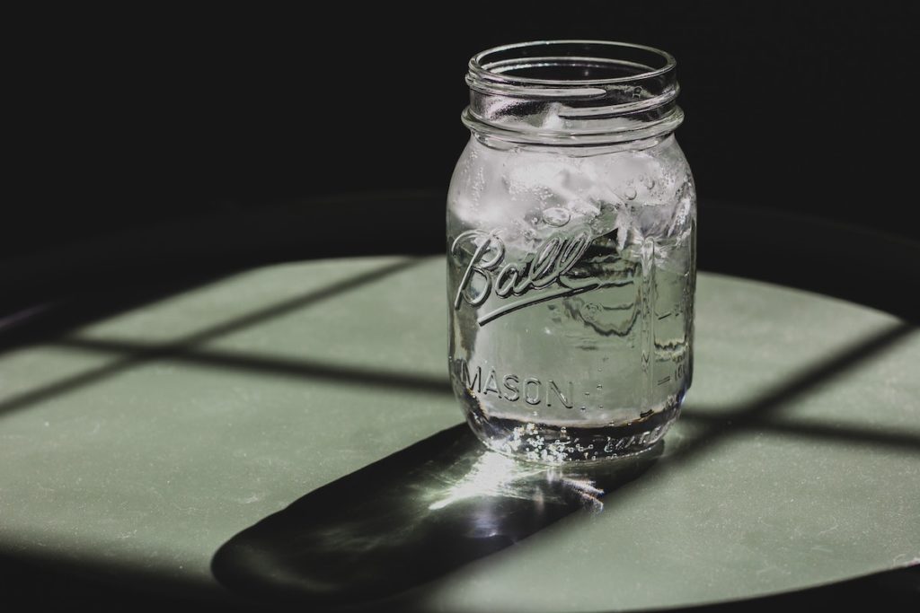 glass of iced water in a mason jar