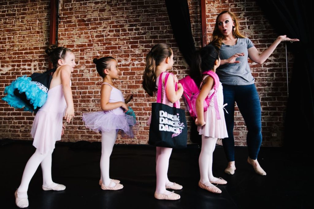 studio owner julie kay stallcup and four small dancers ready to go to class