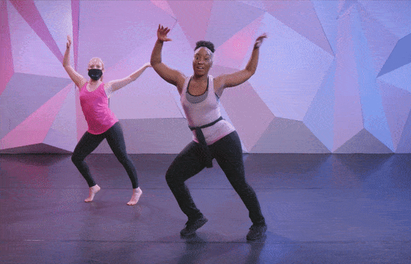 Saleemah E. Knight demonstrates the "spank the baby" dance move at cli studios in front of a purple wall.