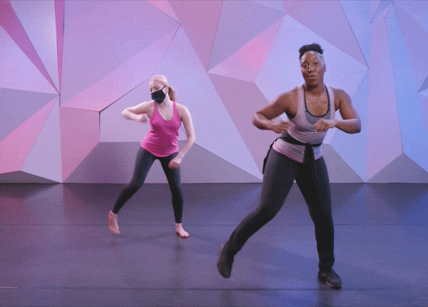 Saleemah E. Knight demonstrates the "attack annie" at cli studios in front of a purple wall. 