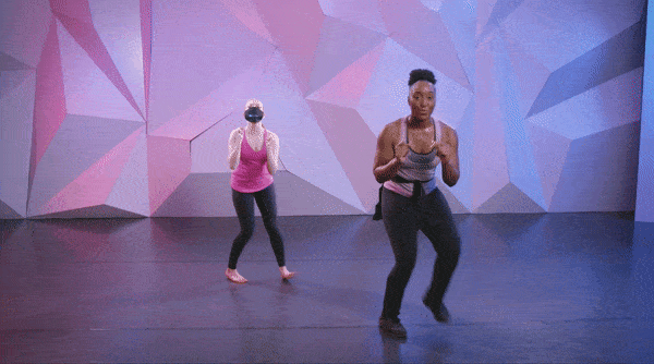 Saleemah E. Knight demonstrating the "apple jack dance" at cli studios infront of a purple wall. 