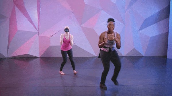 Saleemah E. Knight demonstrating the "apple jack dance" at cli studios infront of a purple wall.