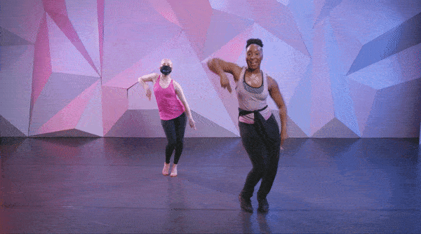 Saleemah E. Knight demonstrating the "apple jack dance" at cli studios infront of a purple wall.