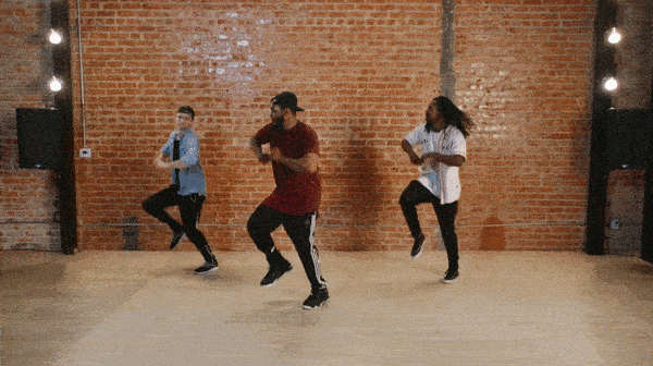 twitch and 2 other dancers performing the steve martin infront of brick wall.