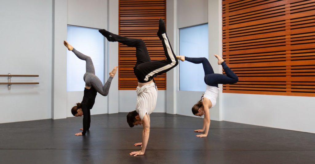 teddy forance and 2 other dancers doing an inversion on hands. 