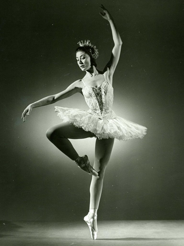 ballet dancer in passé en pointe wearing a tutu
