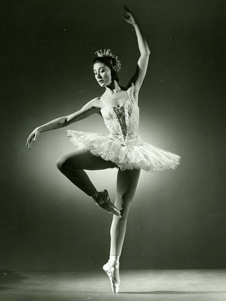 ballet dancer in passé en pointe wearing a tutu