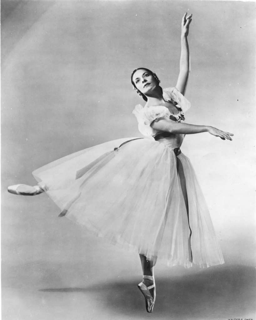 ballet dancer in third arabesque wearing royal tutu en pointe