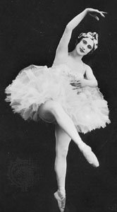 Black and white old photograph ballet dancer in front attitude 
