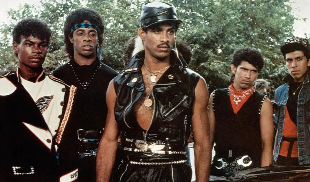 Breakin' the movie 5 guys dressed in leather standing together outside. 