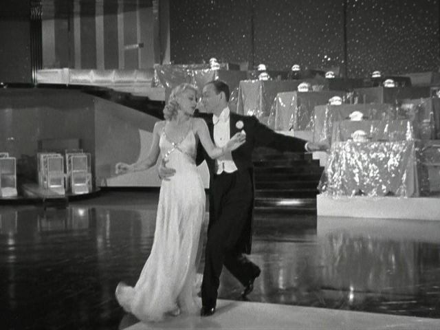 Swing Time the movie with women in white long dress dancing with man in tux.