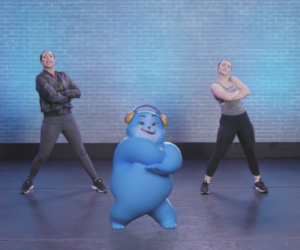 Two dancers and animated blue character dancing