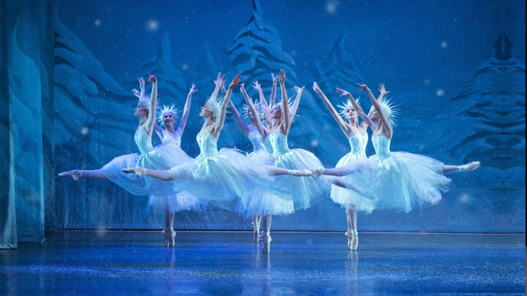 Dancers leap in the snow scene in The Nutcracker
