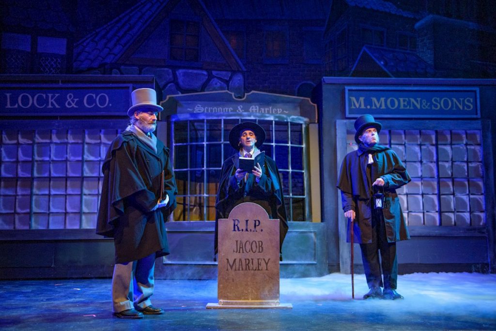 Scene from A Christmas Carol with a tombstone