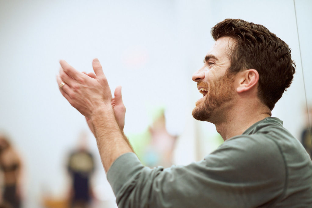 Teddy Forance clapping his hands with an open mouth