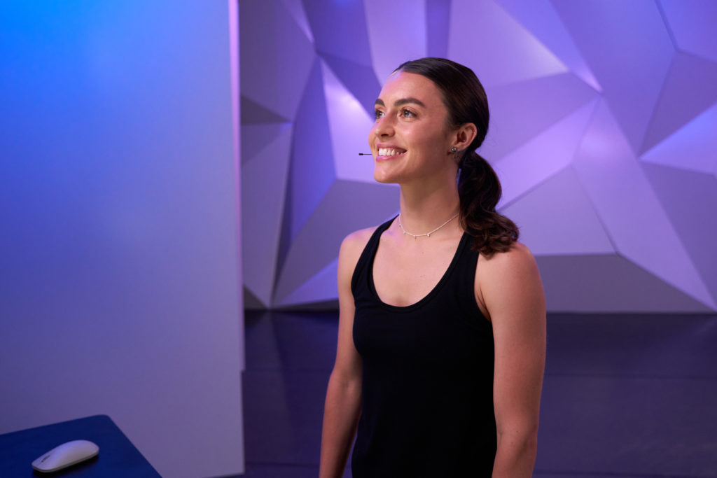 kathryn mccormick standing in front of zoom screen getting ready to teach an online class for CLI Studios.com