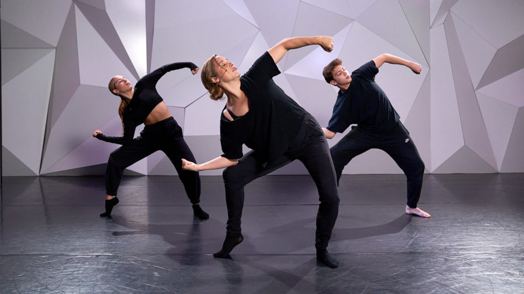 3 lyrical dancers dressed in black with knees bent in a pose looking to the right at cli studios.