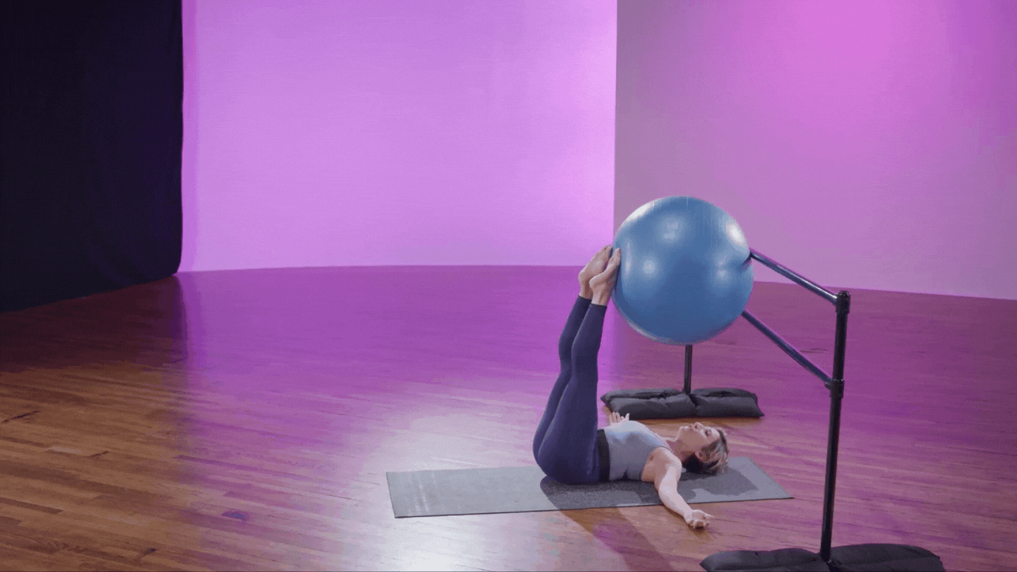 Katie Scharr demonstrating stability ball scissor at cli studios.